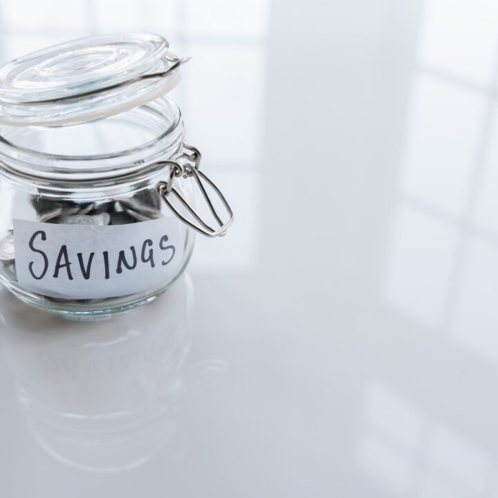 jar labeled savings with money in it