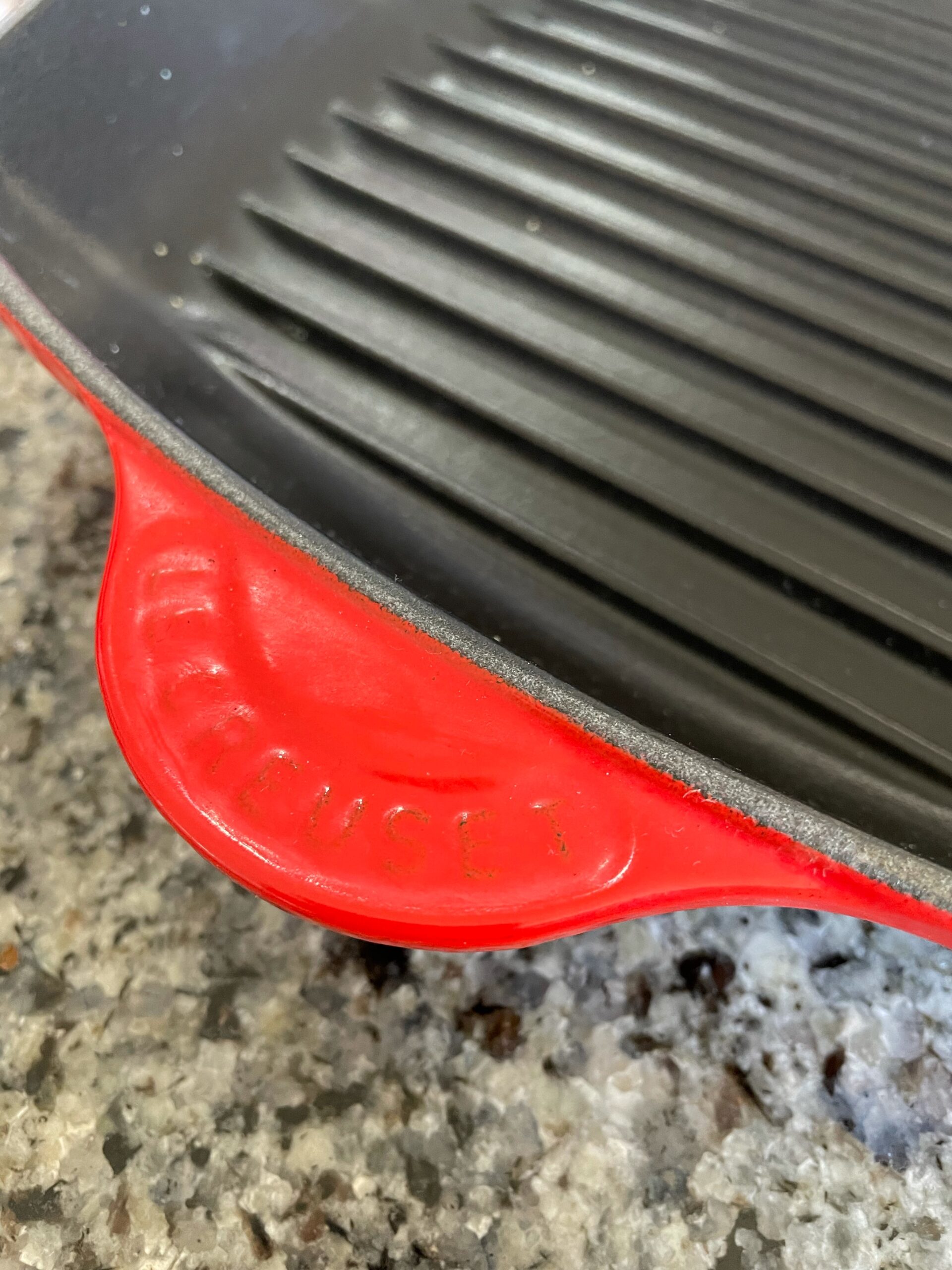 photo of a red enameled le crueset grilling pan