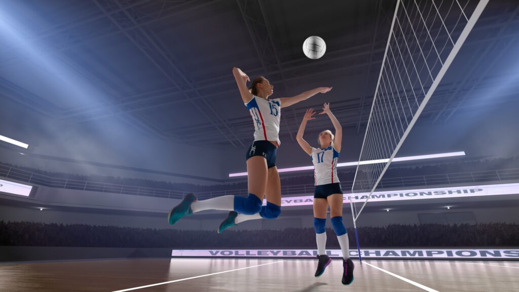 two high school women practicing volleyball in the school gym