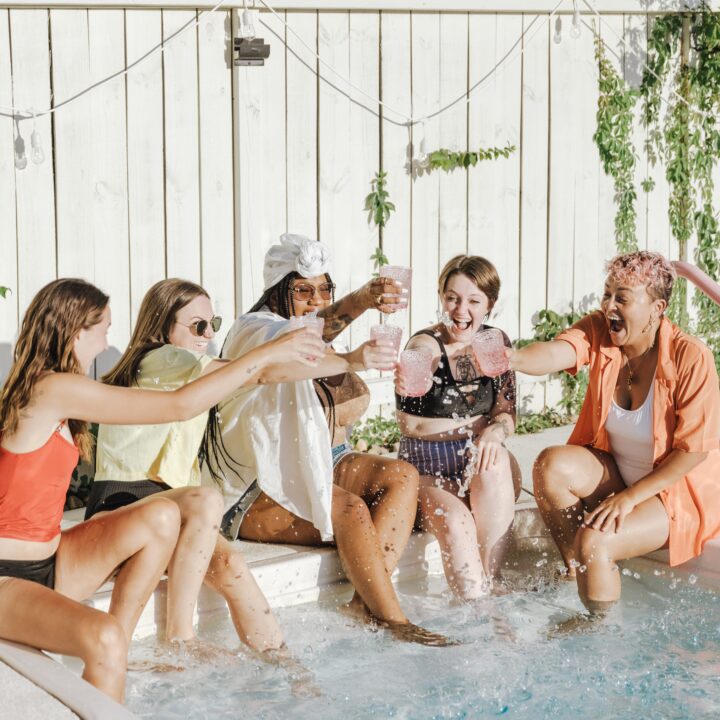 group of friends sitting by the pool