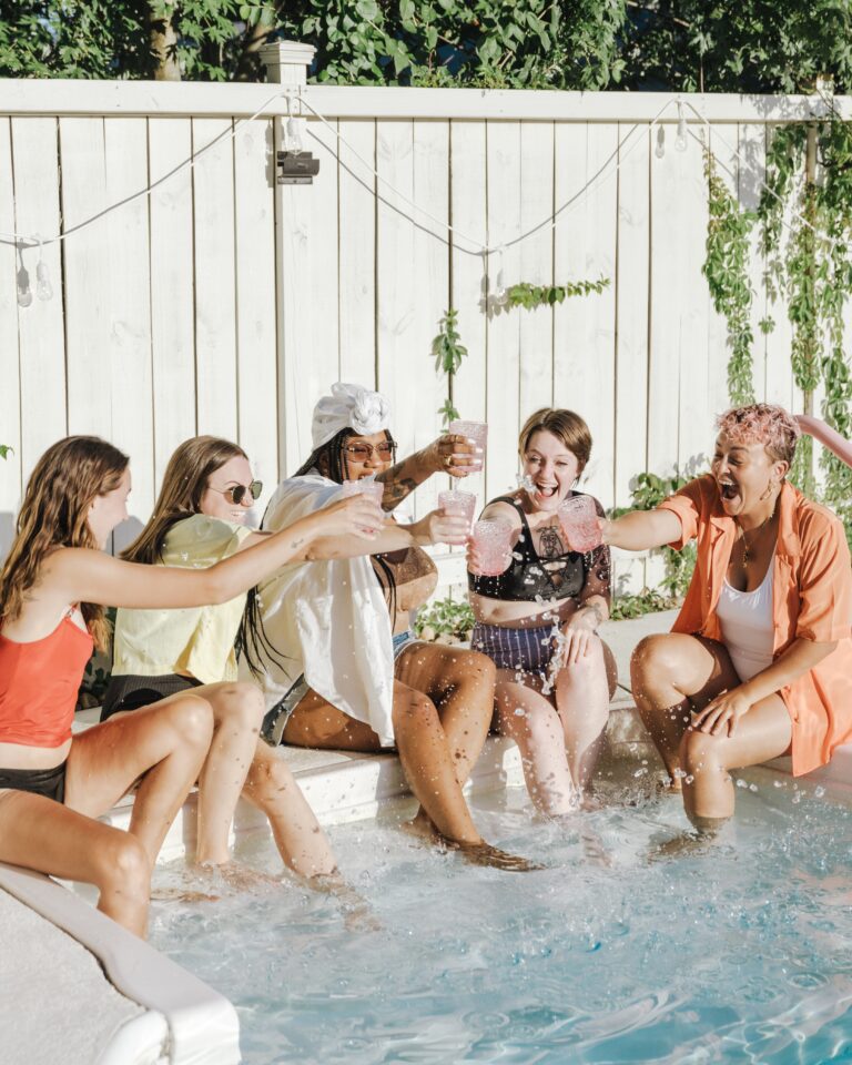 group of friends sitting by the pool