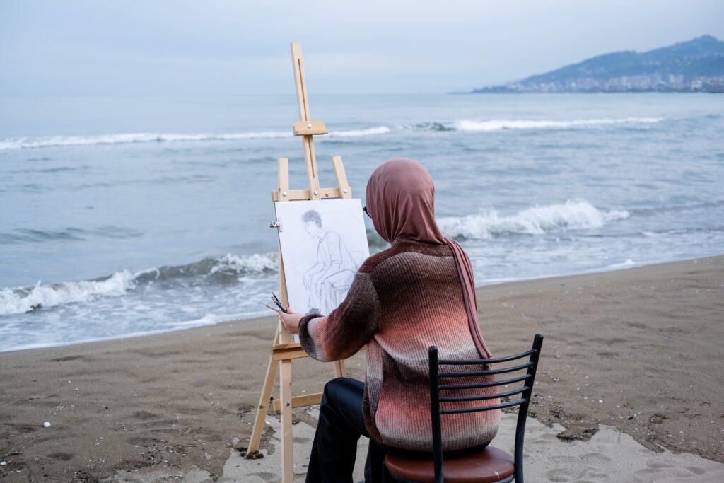 woman drawing on the beach