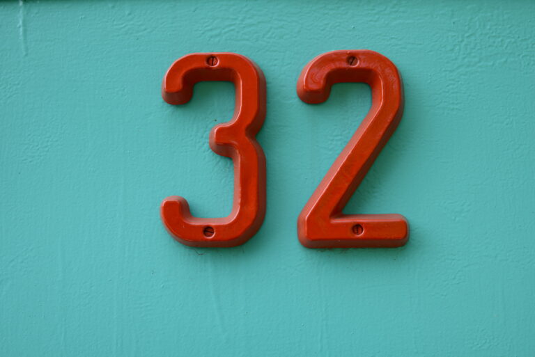 House number 32 Red on a green iron front door