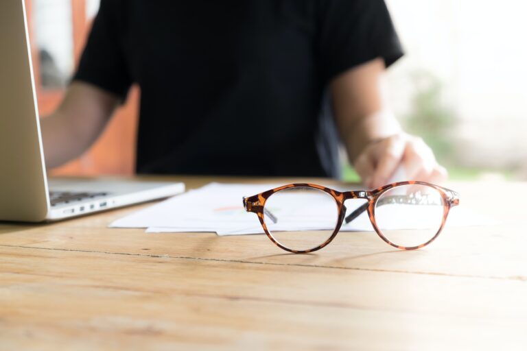 glasses next to computer