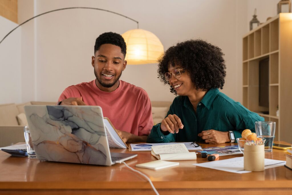 a man and woman sitting at a computer