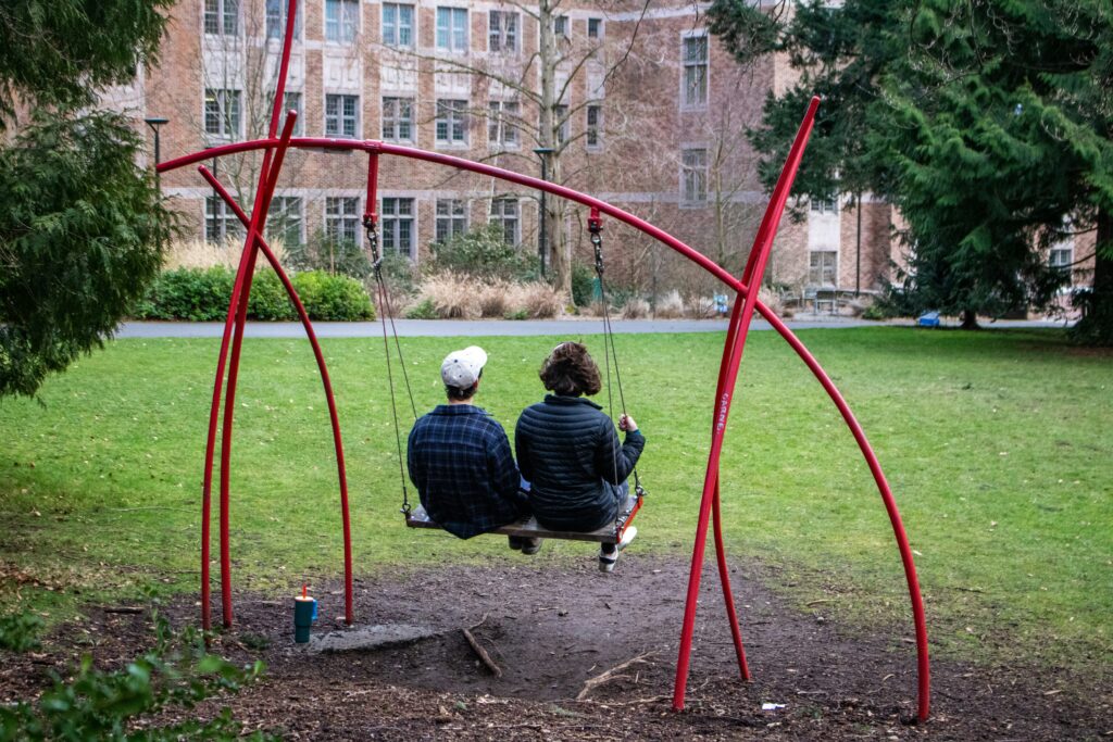 a couple swinging together at a park