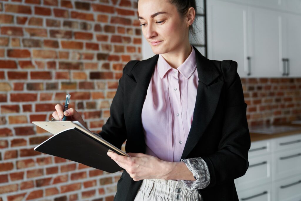 woman writes on a clipboard for work