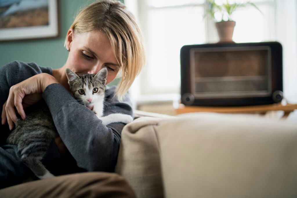 a woman snuggling her cat