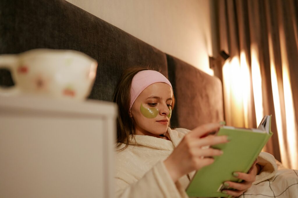 woman reading book in bed to unwind