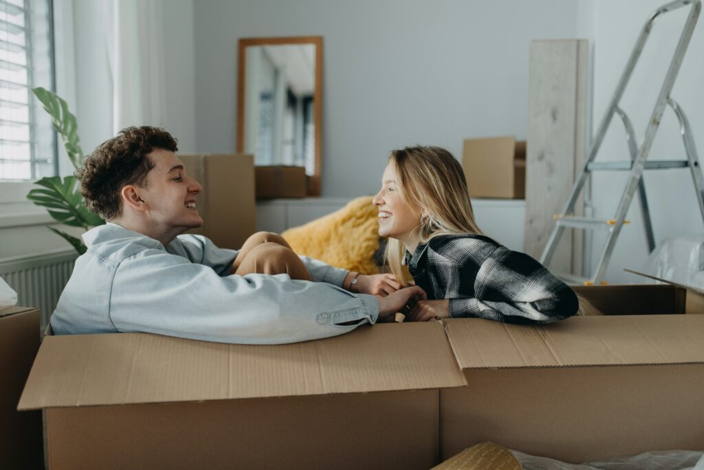 couple sitting together in moving boxes
