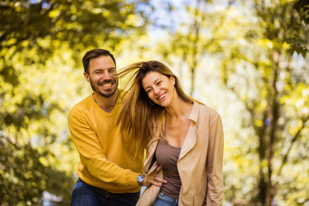 a couple goofing off on a walk together