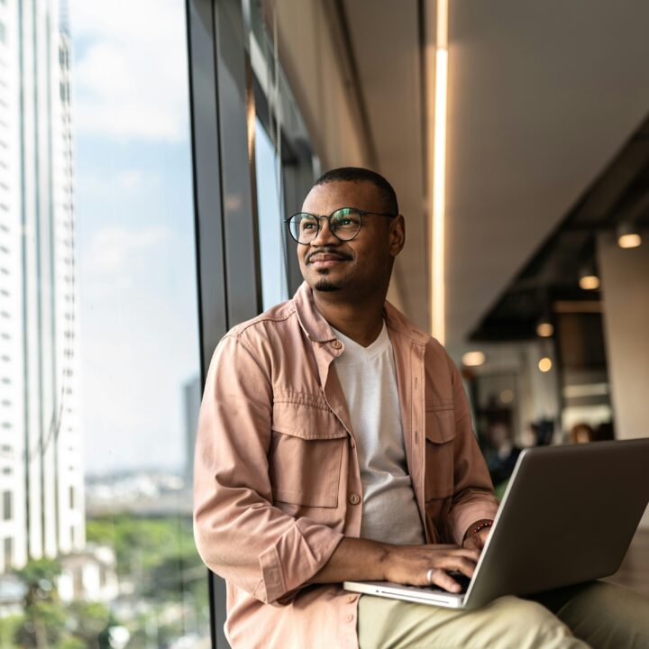 man sitting with a computer