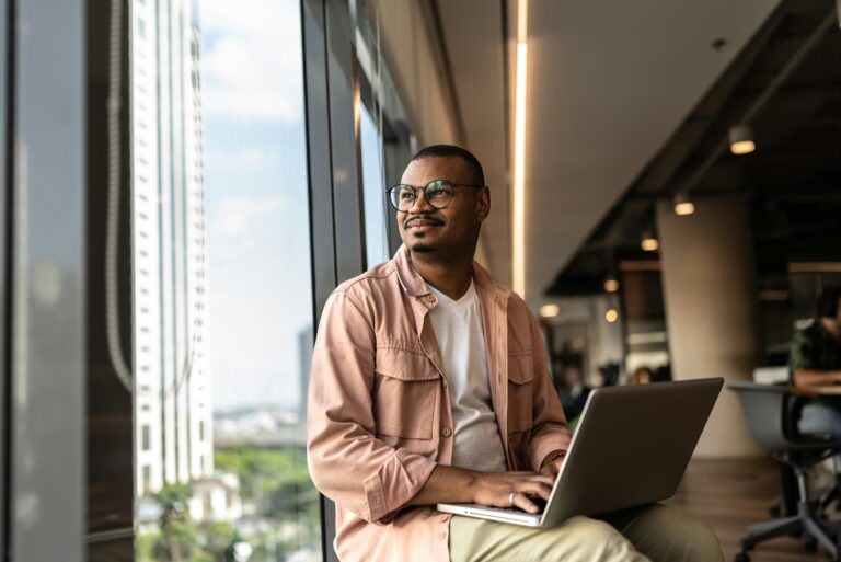 man sitting with a computer