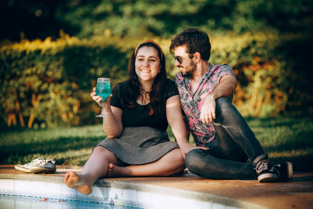 a couple relaxing by the pool