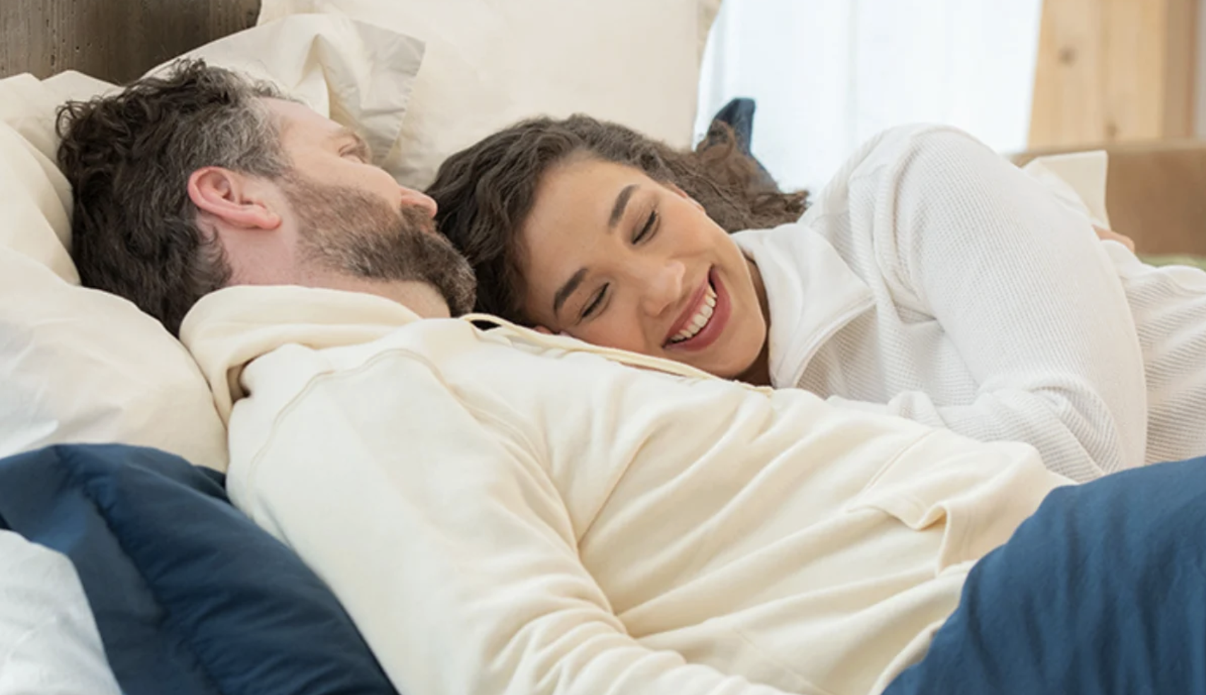 a couple relaxes together in bed