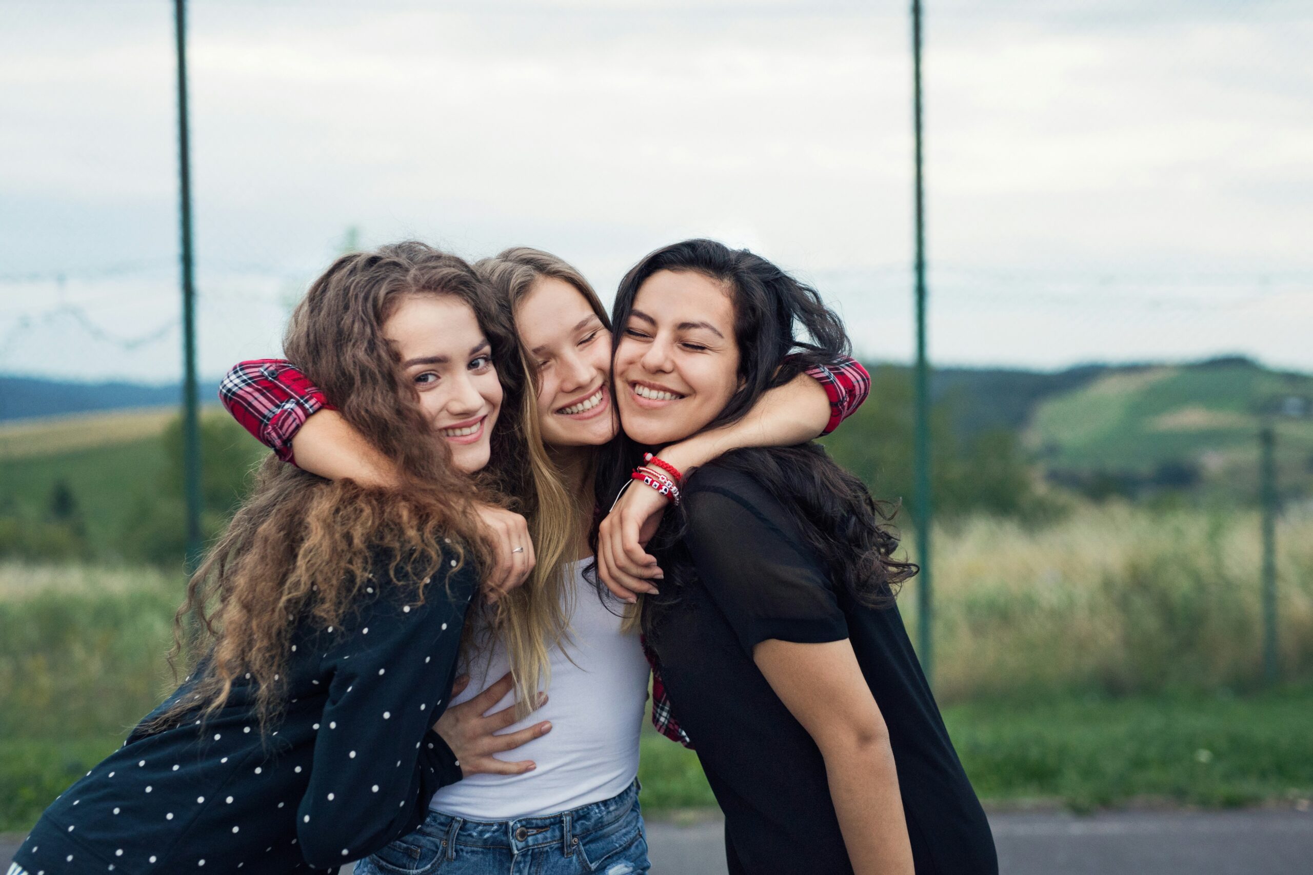 three close friends embrace