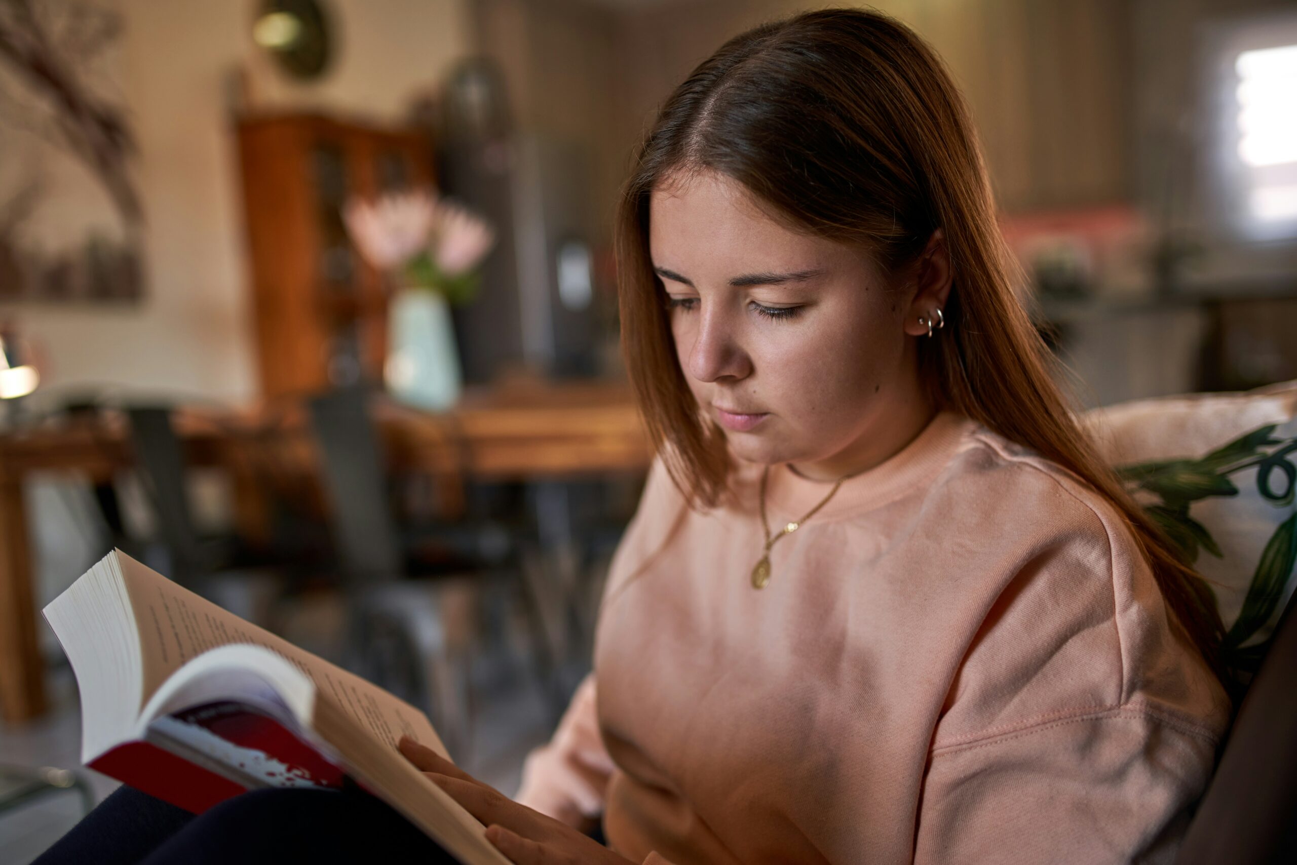 a young woman reads a book