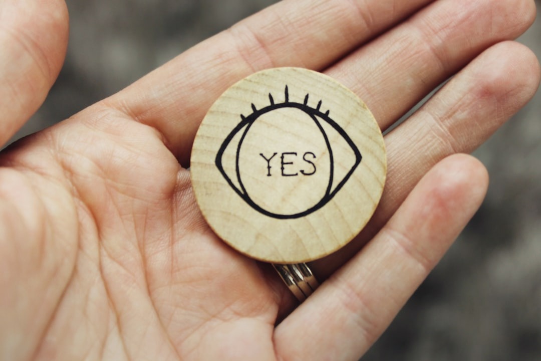 An engraved metal medallion resting in an open hand
