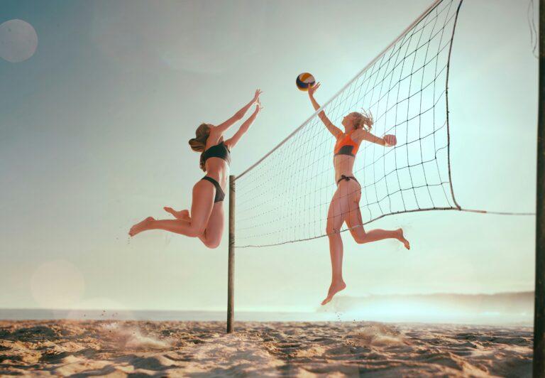 two women playing beach volleyball